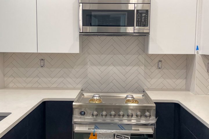 Tiles for kitchen backsplash, marble countertop, and white kitchen cabinets