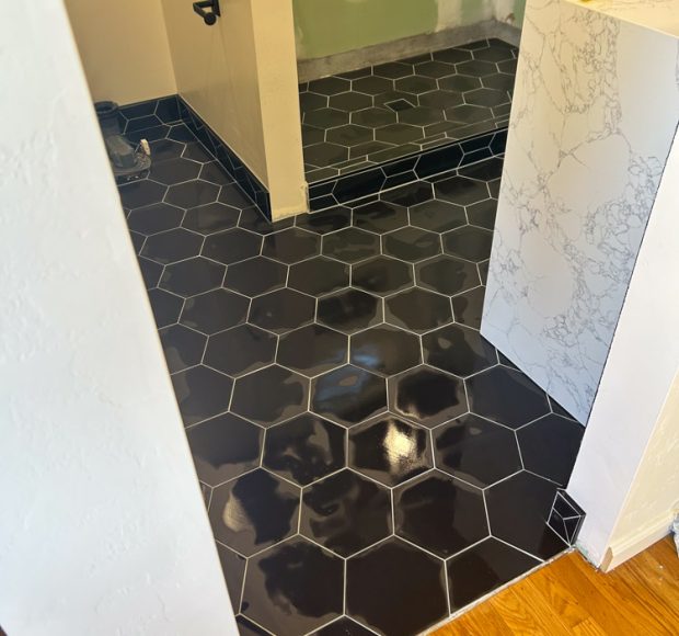 Black hexagonal pattern tiles installed for the bathroom floors