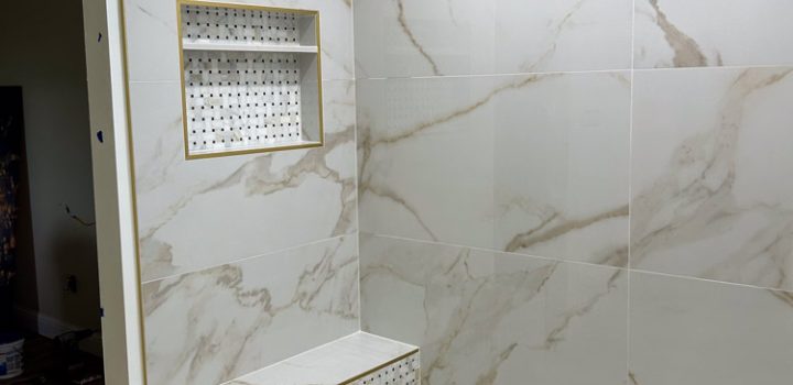 Shower area installed with tile backsplash and flooring