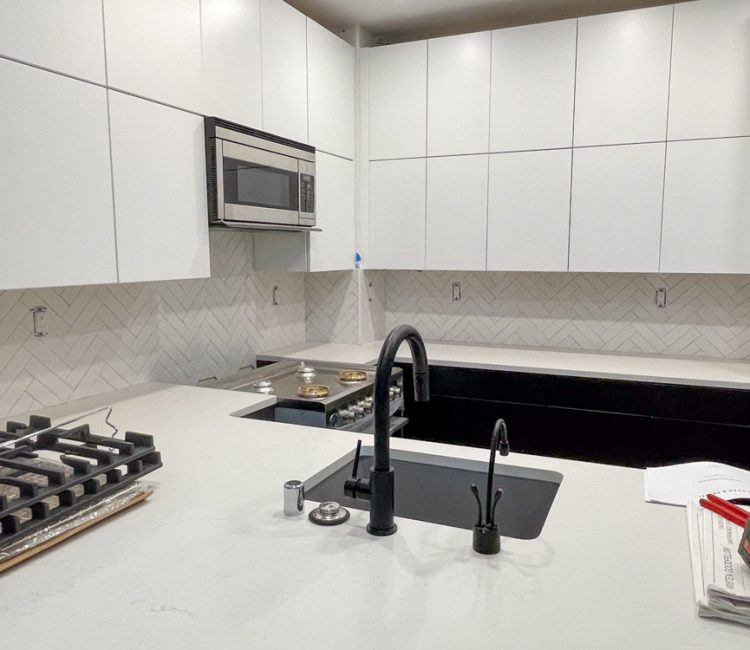 Tiles for kitchen backsplash, marble countertop, and white kitchen cabinets