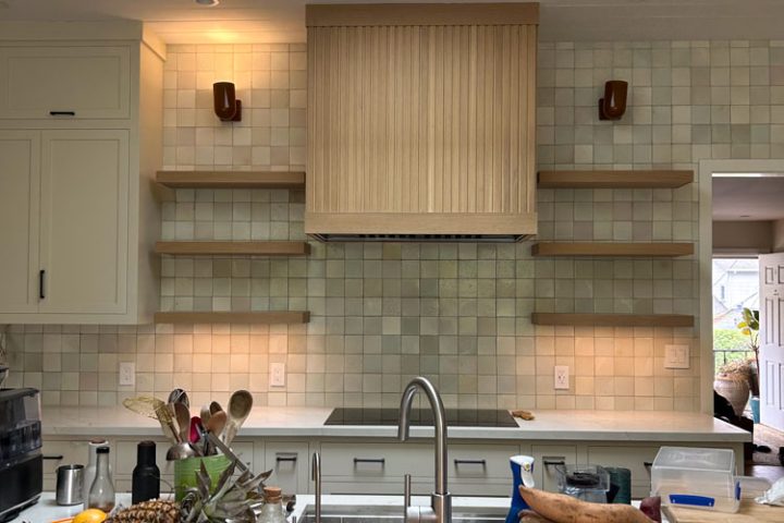 A kitchen remodeled with tile backsplash and wall-mounted shelves