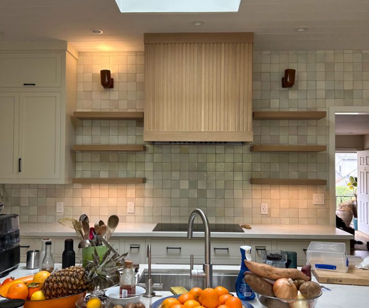 A kitchen remodeled with tile backsplash and wall-mounted shelves