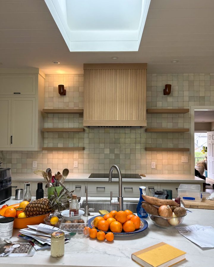 A kitchen remodeled with tile backsplash and wall-mounted shelves