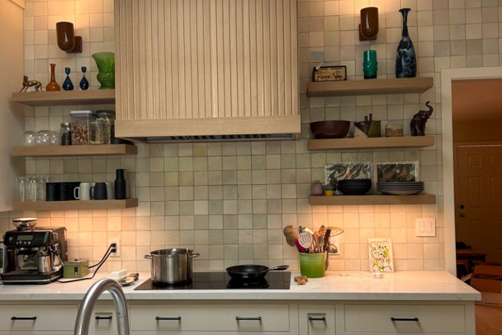 A kitchen remodeled with tile backsplash and wall-mounted shelves