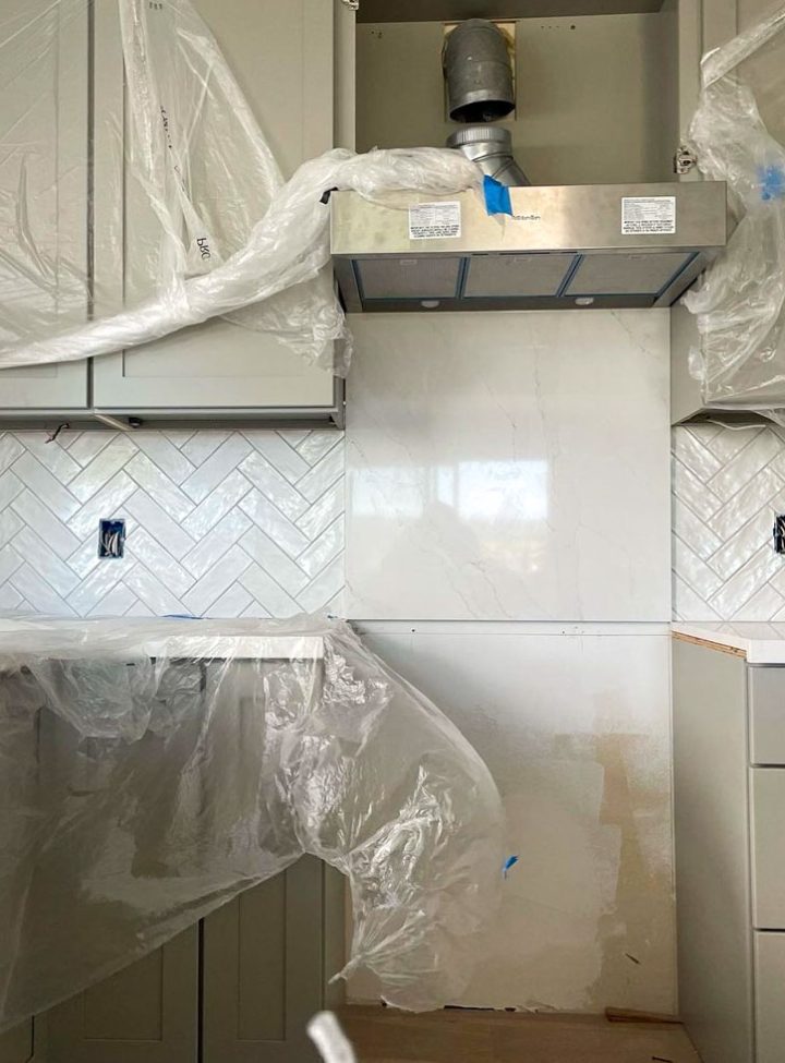 A kitchen remodeling project with installed tiles as kitchen backsplash